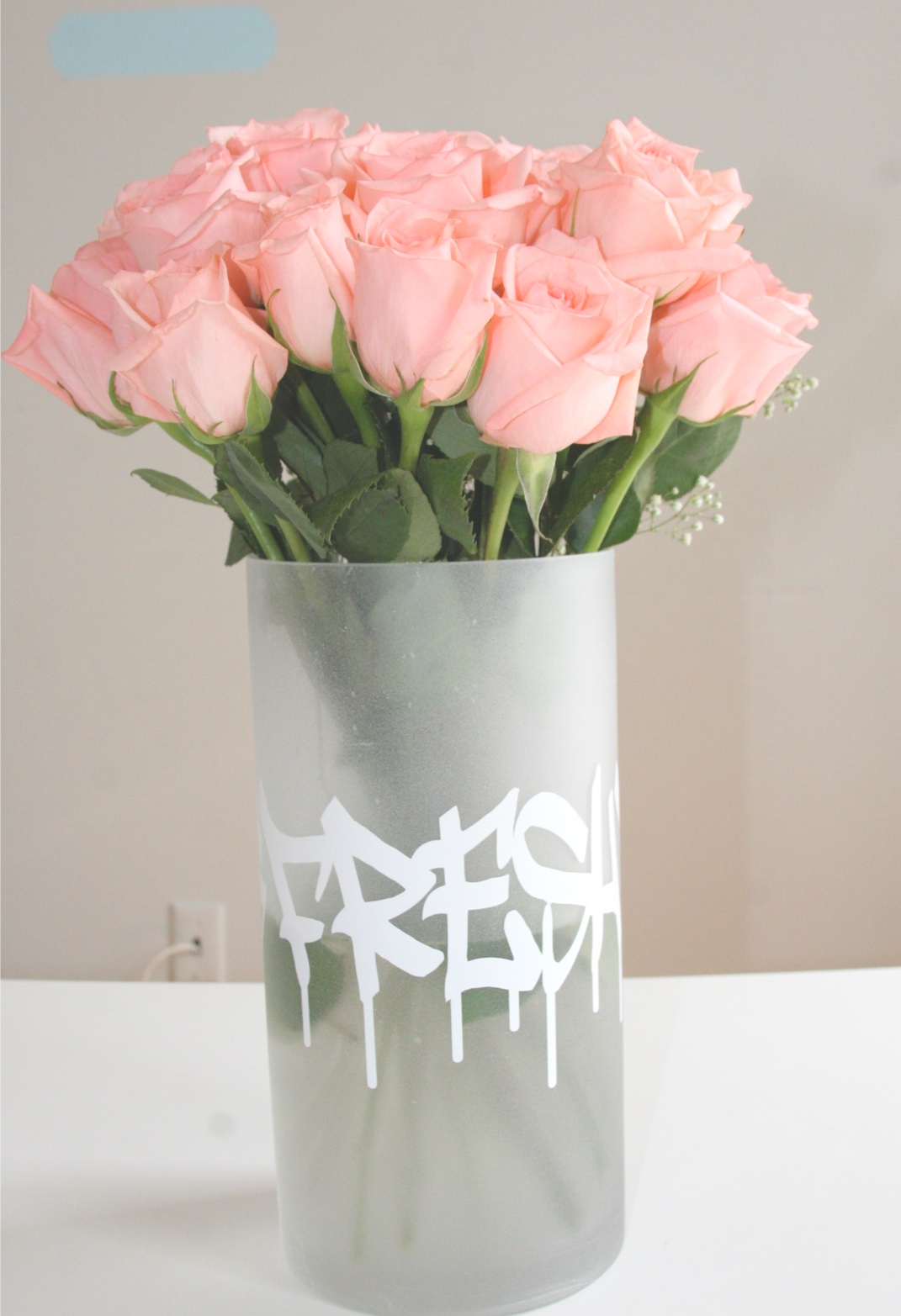Frosted glass vase with graffiti